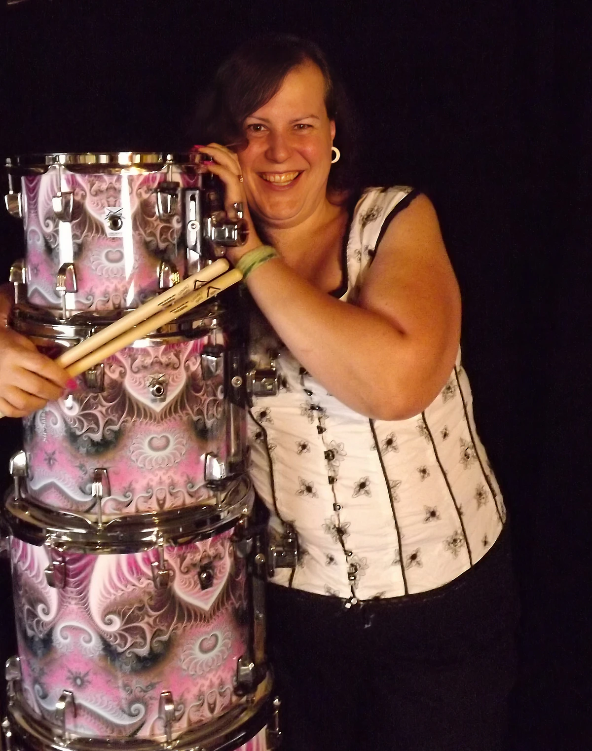 Penny Larson behind a pink drum kit