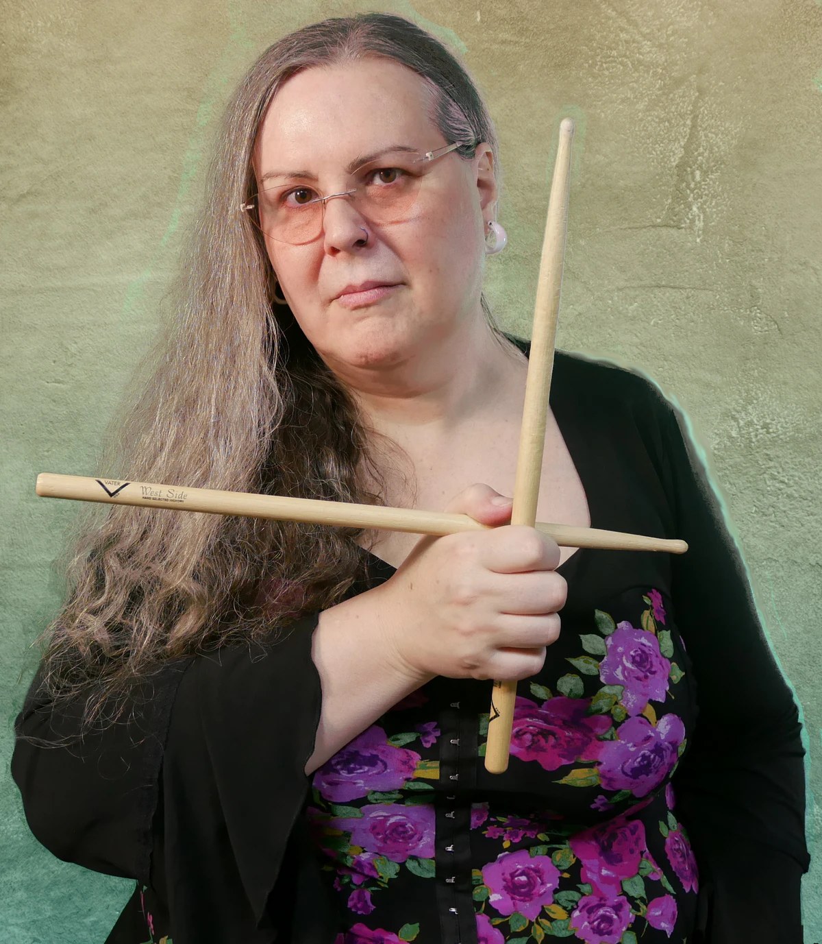 Penny Larson — Vater Percussion artist endorser, holding Vater drumsticks in her studio